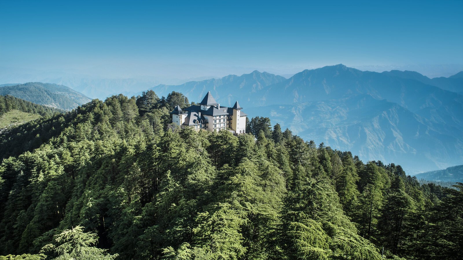 Wildflower Hall-style mountaintop retreat above pine forests in the Indian Himalayas