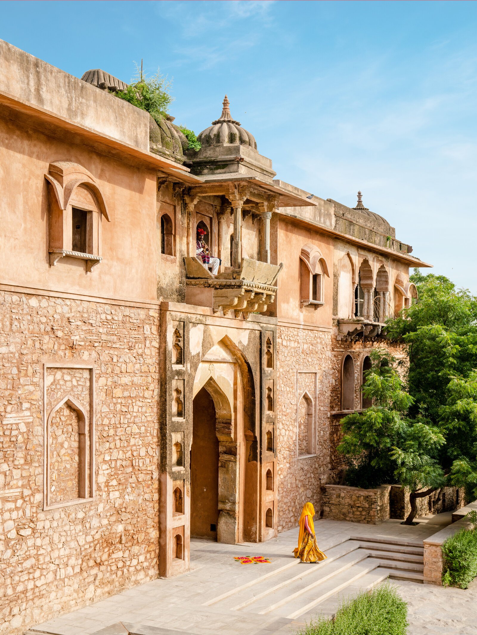 Heritage haveli entrance with a figure in saree