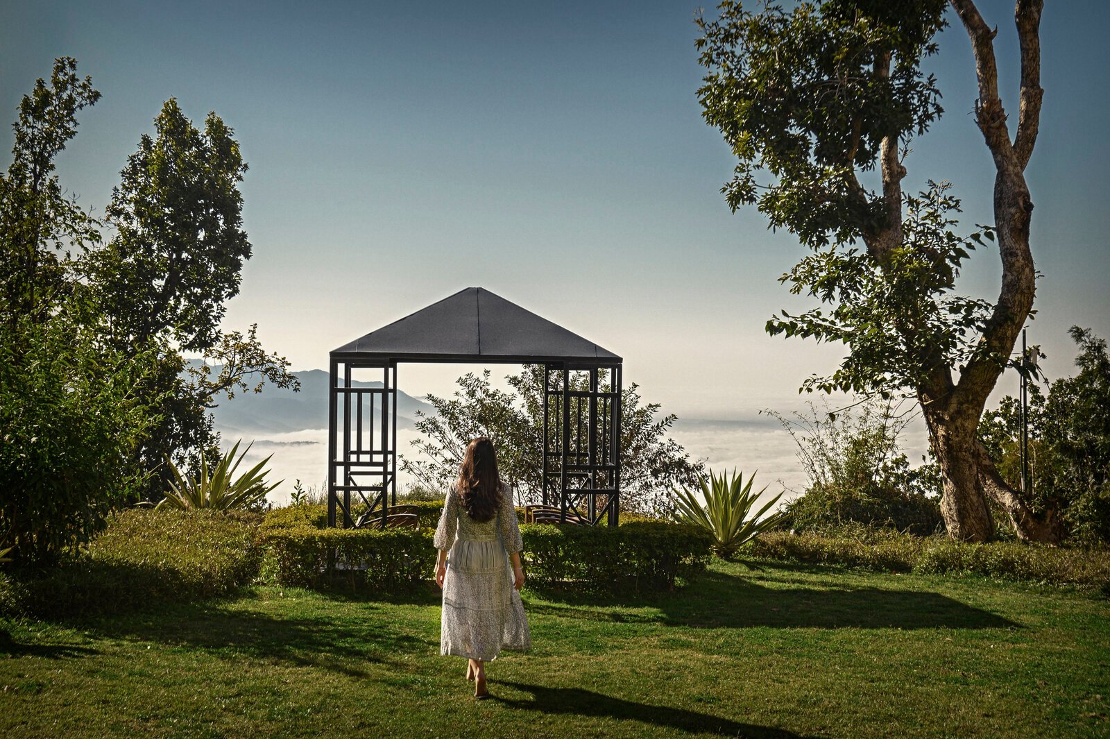 Quiet wellness pavilion overlooking mist-covered Himalayan foothills