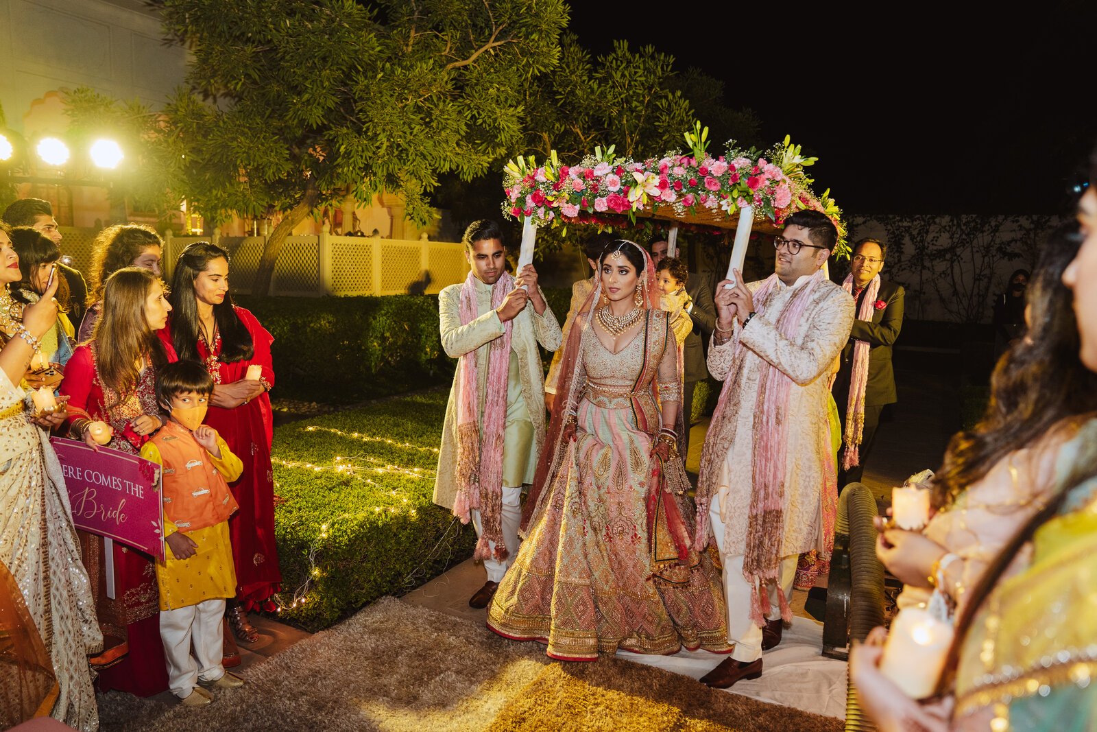 Bride entering under floral canopy at palace wedding