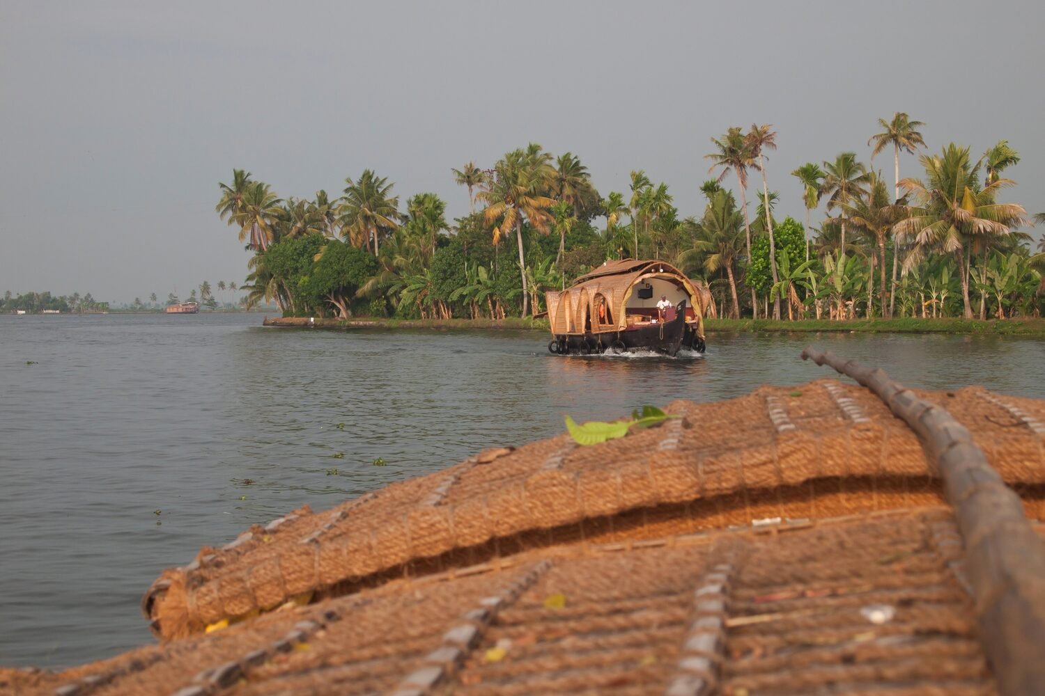 A houseboat drifting through Kerala's palm-fringed backwaters