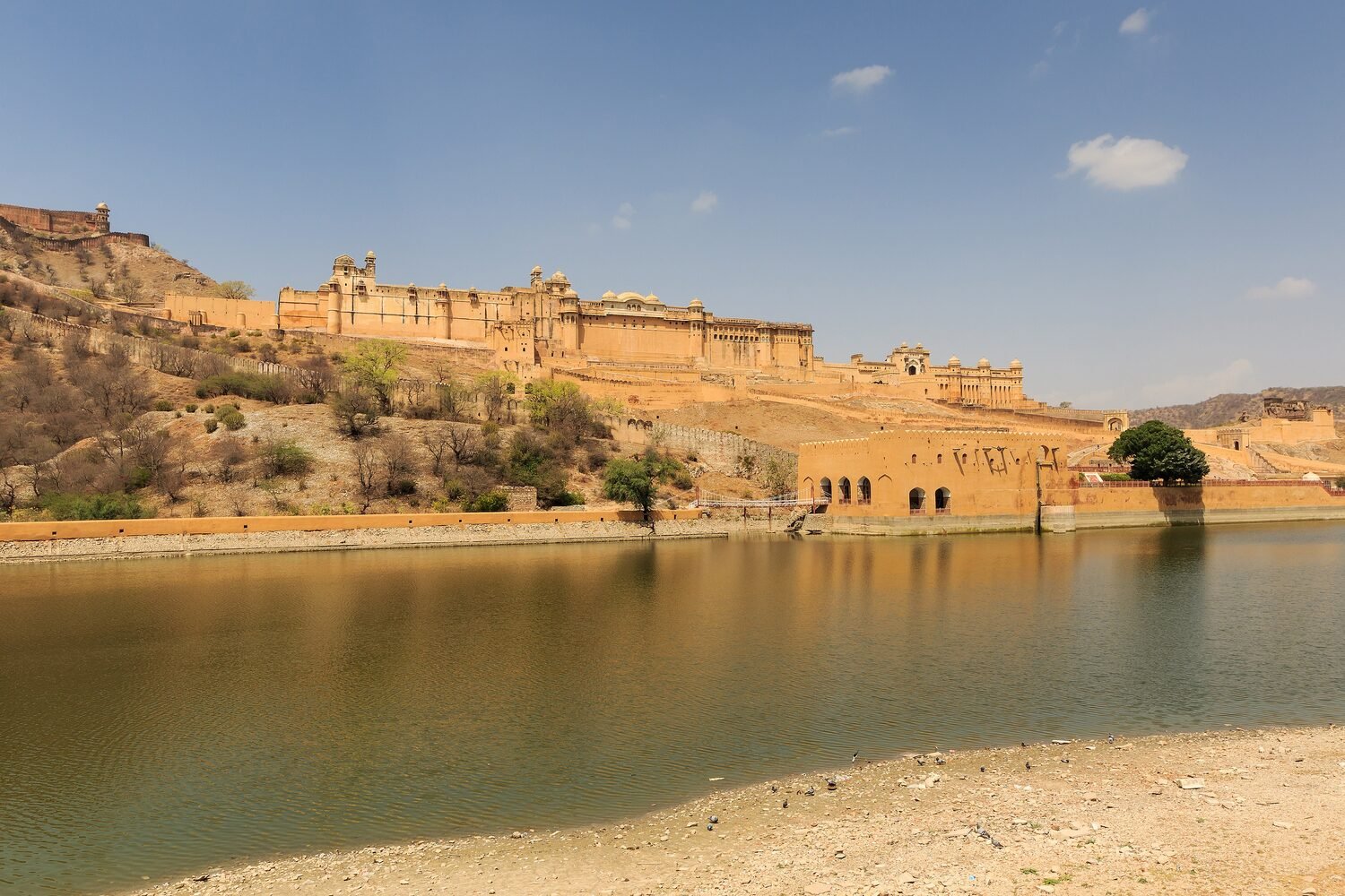 Amber Fort reflected in the still water of Maota Lake near Jaipur
